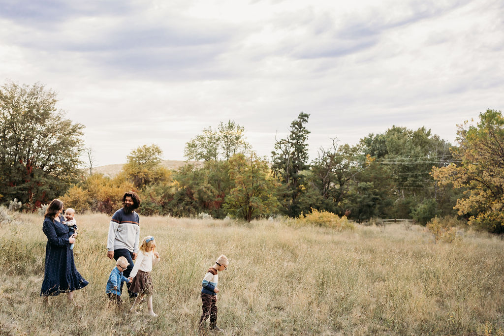 Family walking in a boise field
